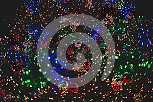 Mirror balls hanging on the Christmas tree. garlands of green, red and blue colors. holiday christmas concept, background of