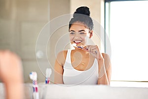 Mirror, dental care and woman with toothbrush in bathroom for morning hygiene teeth routine. Smile, wellness and female