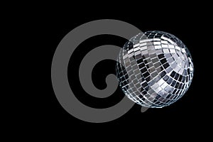 Mirror disco ball on black background. Brilliant decoration, silver decor.