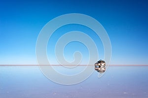 Mirror effect and reflections of a 4x4 car in Salar de Uyuni Uyuni salt flats, Potosi, Bolivia