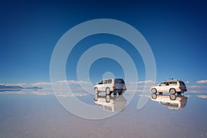 Mirror effect and reflections of 4x4 cars in Salar de Uyuni Uyuni salt flats, Potosi Bolivia, South America