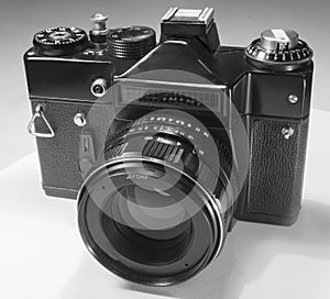 Mirror film camera with external photocell and manual exposure control and interchangeable lenses