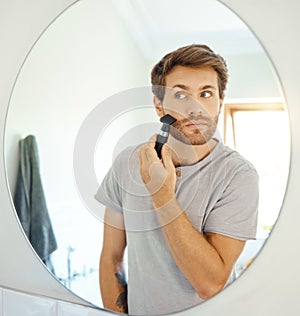 Mirror, grooming and a man shaving in the bathroom of a home in the morning for personal hygiene. Electric razor