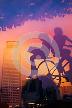 Mirror image, internal view of a book shop and mirrored picture of children ride bike in foregrounds. Bangkok City at twilight