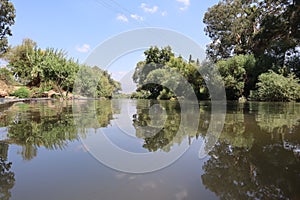 A mirror image of the Jordan River in the Kfar Blum Dam in Israel