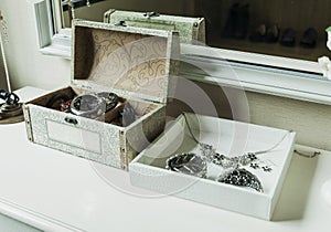 Mirror,jewelry and makeup box on a table