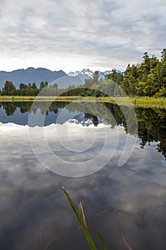 Mirror Lake reflects New Zealand`s glaciated Southern Alps