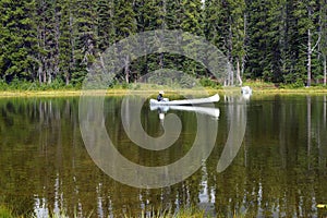 Mirror Lake and a white canoe fisherman.