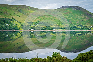 Mirror like reflections over Loch Broom in a cloudy morning.