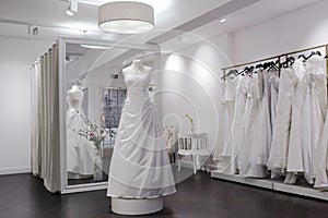 Mirror, mannequin and changing room in bridal shop