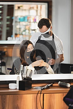 Mirror reflection of hairdresser in face