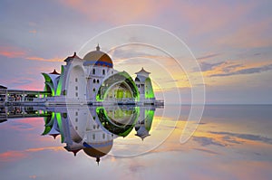 Mirror reflection of majestic floating mosque at malacca straits