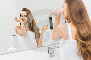 mirror reflection of smiling woman