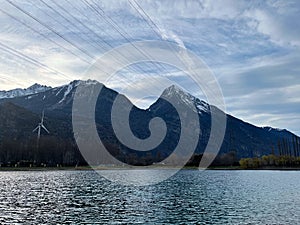 Mirror reflection of a snow-covered mountain in a lake with mountain water in Martigny, Switzerland