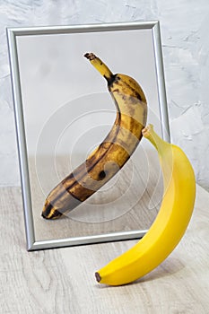 The mirror reflects a spoiled banana.