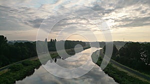 Mirror sky: aerial view of sunrise reflection over river