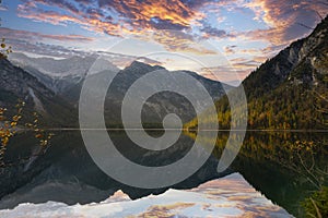 Mirror-smooth lake plansee in the tyrolean mountains in autumn with mountains reflected photo