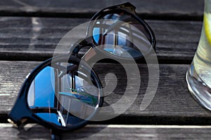 Mirror sunglasses on wooden table