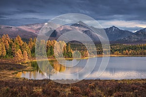 Mirror Surface Lake Beautiful Autumn Landscape With Snowy Mountain Range On Background