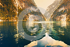 Mirror surface of lake Koenigsee reflecting the rocky mountains