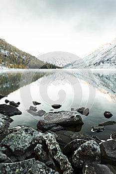 Mirror surface of the mountain lake. Beautiful nature, a trip to the mountains in a national Park in Altai Republic