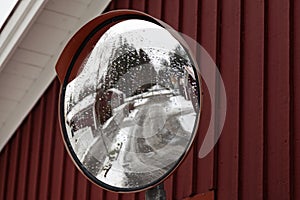 Mirror for traffic in wintry residential area in Umea