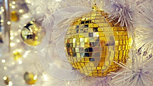 Mirrored disco ball and Christmas decorations on a white background.