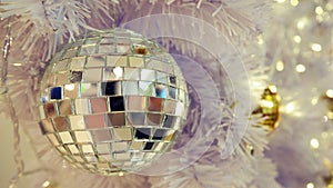 Mirrored disco ball and Christmas decorations on a white background.