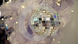 Mirrored disco ball and Christmas decorations on a white background.