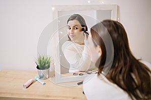 Mirrored image of a girl blushing her cheekbone photo