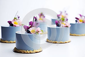 mirrorglazed blueberry entremets neatly arranged in a row