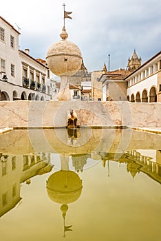 Mirroring in the fountain Porta de Moura in Evora ,Portugal