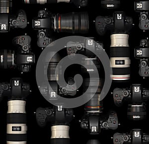 Mirrorless Cameras with different lenses for shooting videos. Top view of digital cameras isolated on black background.
