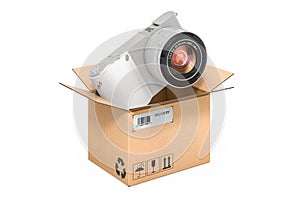 Mirrorless digital camera inside cardboard box, delivery concept. 3D rendering