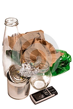 Miscellaneous household trash: glass, plastic, paper, metal, phone battery on white background. Recycling concept