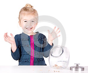 Mischievous girl steals cookies from cookie jar