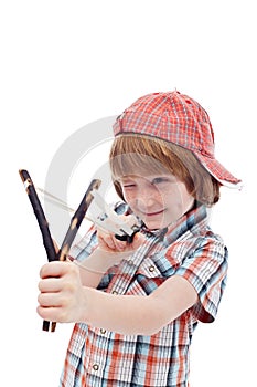 Mischievous kid aiming with sling photo