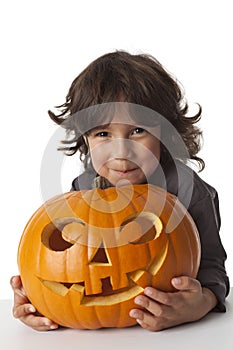 Mischievous Little boy with a Halloween pumpkin