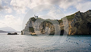 Miseno Cape with lighthouse as seen from the ferry to Procida. Naples, Campania, Italy.