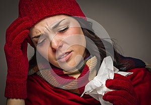 Miserable Mixed Race Woman Blowing Her Sore Nose with Tissue