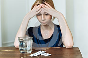 Miserable woman feeling sick with flu, having fever and blowing runny nose. Depression in a woman. Take antidepressants