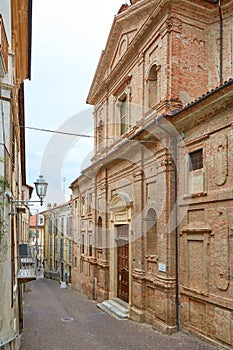 Misericordia church with red bricks facade in the upper part of Mondovi city, Italy photo