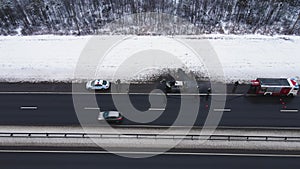 Misfortune - a burned-out car on the edge of a motorway, aerial view.