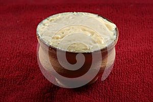 Mishti Laal doi or dahi or bengali sweet curd isolated on red background photo