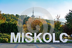 Miskolc text sign in the Park downtown with radio tv tower background photo