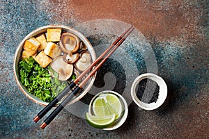 Miso and soba noodles soup with kale, shiitake mushrooms, roasted tofu.