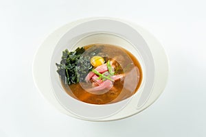 Miso soup with tuna, buckwheat noodles, quail egg, seaweed isolated on white background