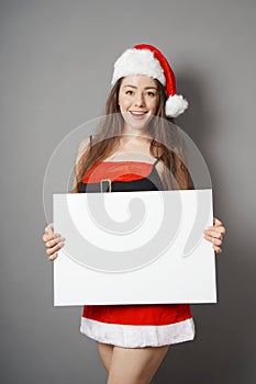 Miss santa presenting blank sign with copy space