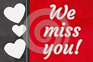 We miss you type message on red plush material and hearts