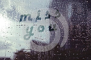 Miss You on wet window glass